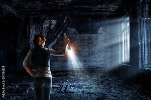 Young woman holding a flashlight