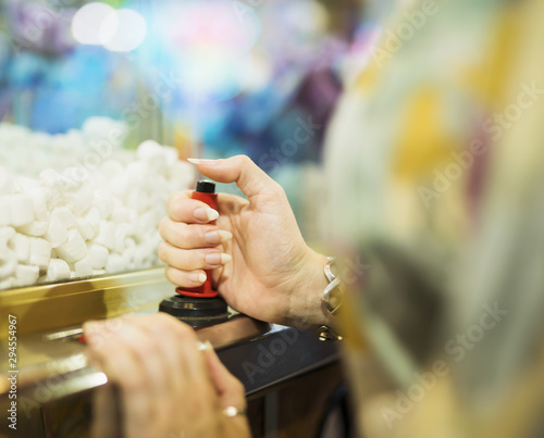 Woman playing with claw machine