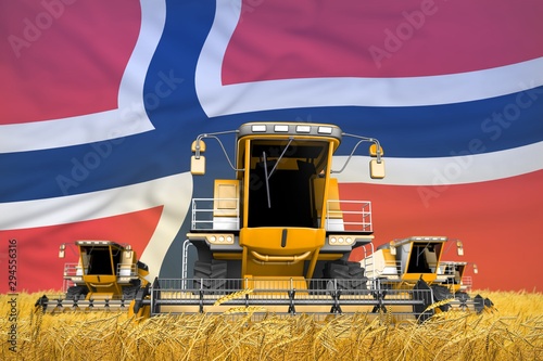 Fotografie four orange combine harvesters on farm field with flag background, Norway agricu
