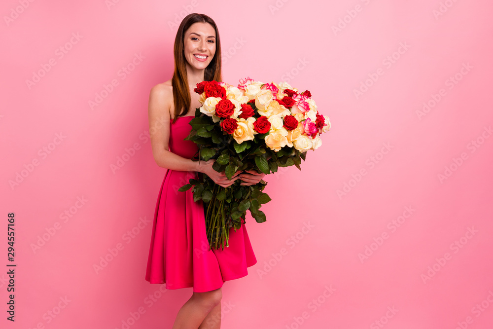 Portrait of nice-looking attractive lovely pretty cheerful glad red haired girl holding in hands big large huge bouquet different roses stem congrats isolated over pink pastel color background