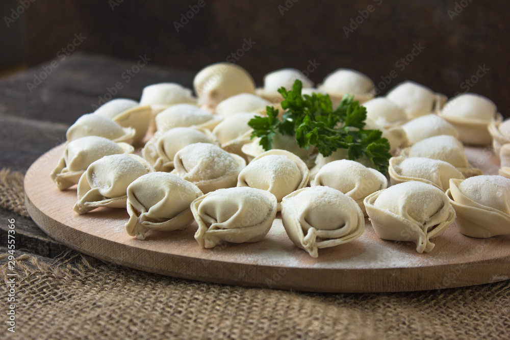 Raw Russian dumplings on the cutting board. Raw Russian dumplings on the cutting board.