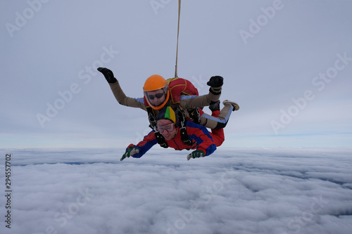Tandem skydiving. Two men are flying in the sky together and having fun.