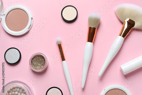 Flat lay composition with makeup brushes on pink background
