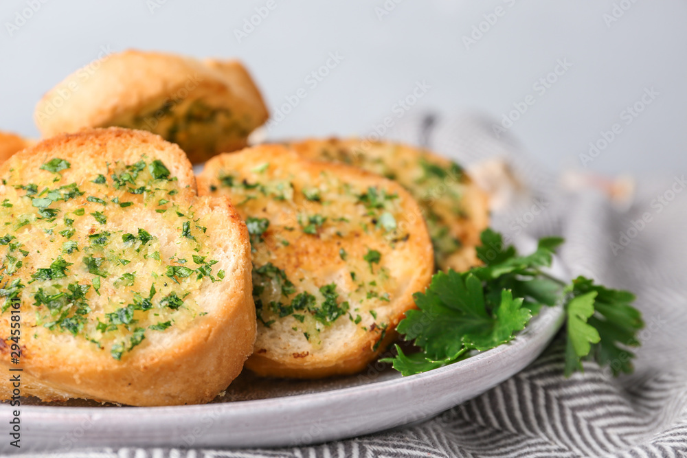 Slices of toasted bread with garlic and herbs on table, closeup Slices of toasted bread with garlic and herbs on table, closeup
