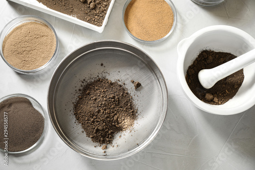 Laboratory equipment for pulverizing and sieving of soil samples on light table, flat lay photo