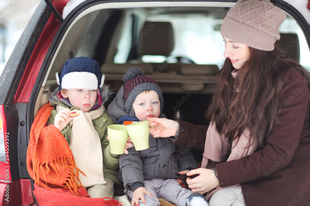Mom and two sons in a car with hot coffee, car