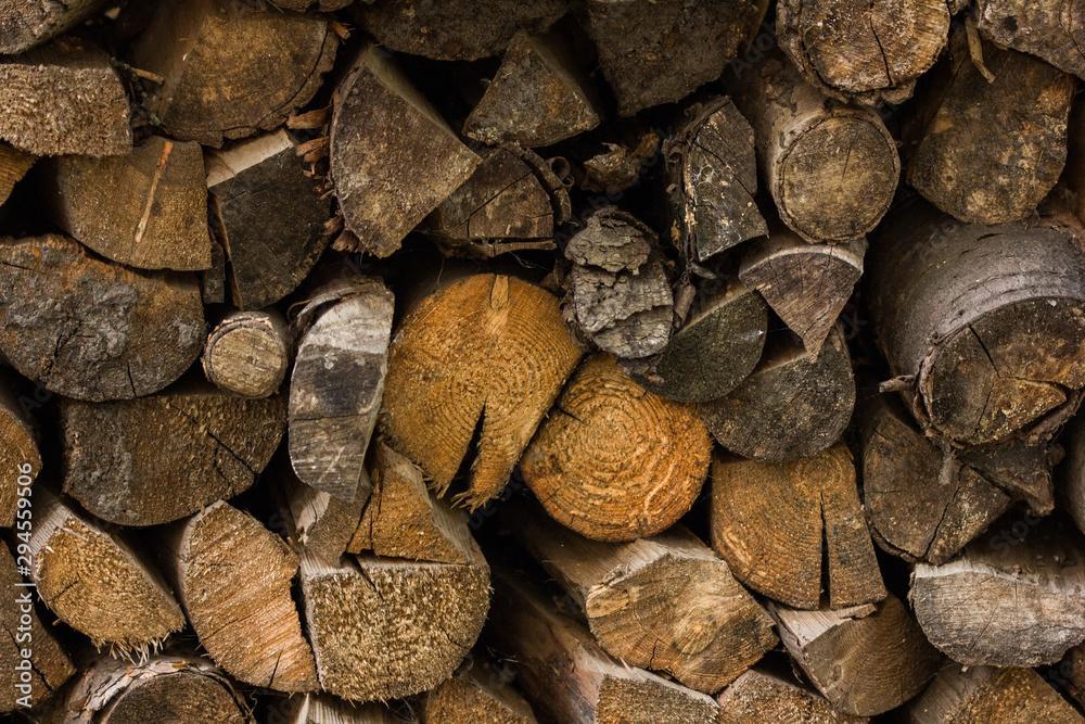 A bunch of logs. Firewood texture. Brown wooden lumber background. Old wall wood vintage texture. Grunge wooden rustic textured, white wood, surface. A bunch of logs. Firewood texture. Brown wooden lumber background. Old wall wood vintage texture. Grunge wooden rustic textured, white wood, surface.