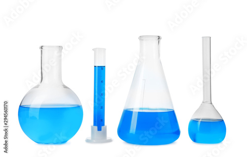 Laboratory glassware with blue liquids isolated on white