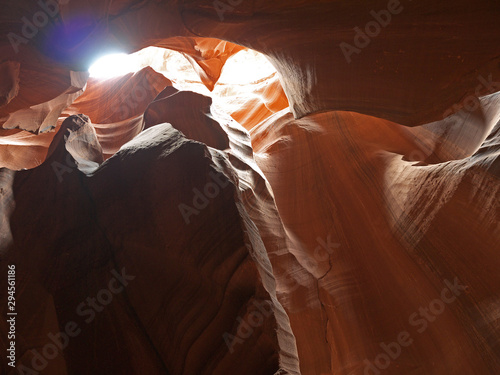 Looking up at Low Antelope canyon, stunning view with sunlight falling on eroded red sandstone walls