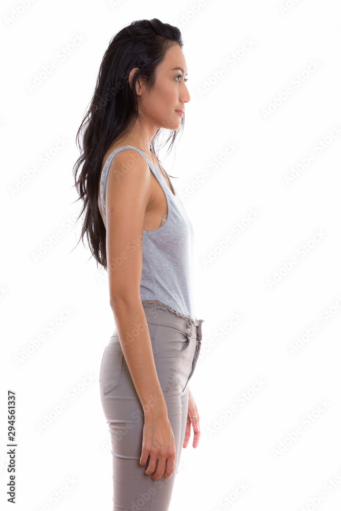 Profile view of young beautiful Asian woman standing Profile view of young beautiful Asian woman standing