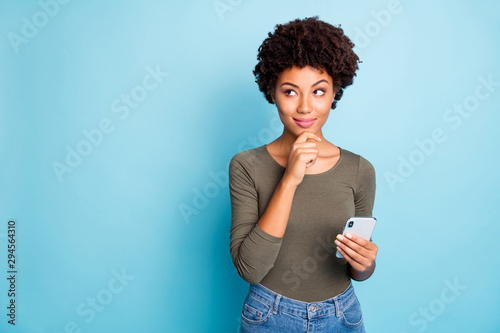 Quadro em tela Photo of cunning smirking puzzled interested dark skinned youngster touching her