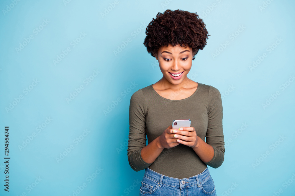 Portrait of amazed funky girl use her smartphone read feednews got like from favorite blogger feedback scream wow omg wear green stylish pullover isolated over blue color background Portrait of amazed funky girl use her smartphone read feednews got like from favorite blogger feedback scream wow omg wear green stylish pullover isolated over blue color background