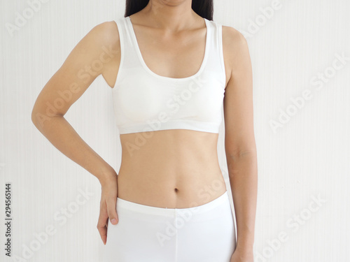 weight loss and slim body in woman and she showing her waistline curve and belly fit and firmming use for workout,fitness or diet and burn or detox and dietary supplement product on white background.