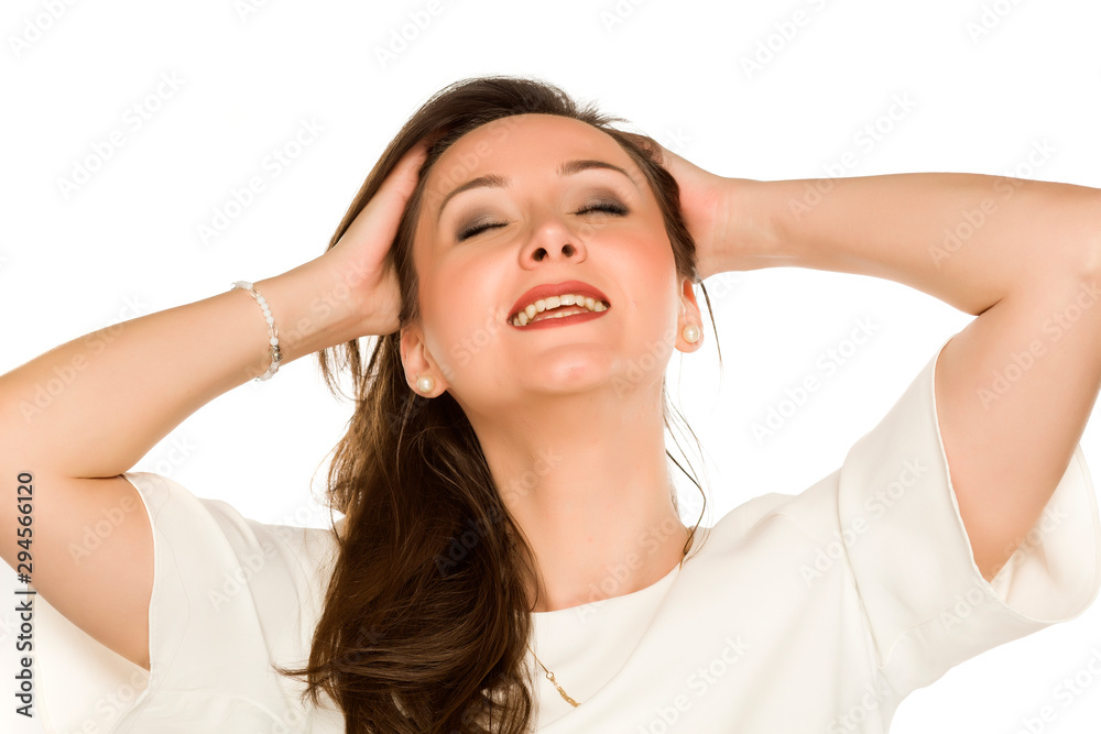 Youngs happy woman holding her hair on white background Youngs happy woman holding her hair on white background