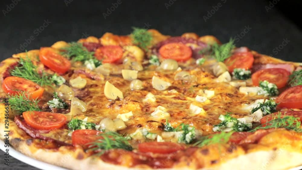Delicious pizza, which rotates natals. Pizza with sausage, tomatoes and mushrooms. Delicious pizza, which rotates natals. Pizza with sausage, tomatoes and mushrooms.