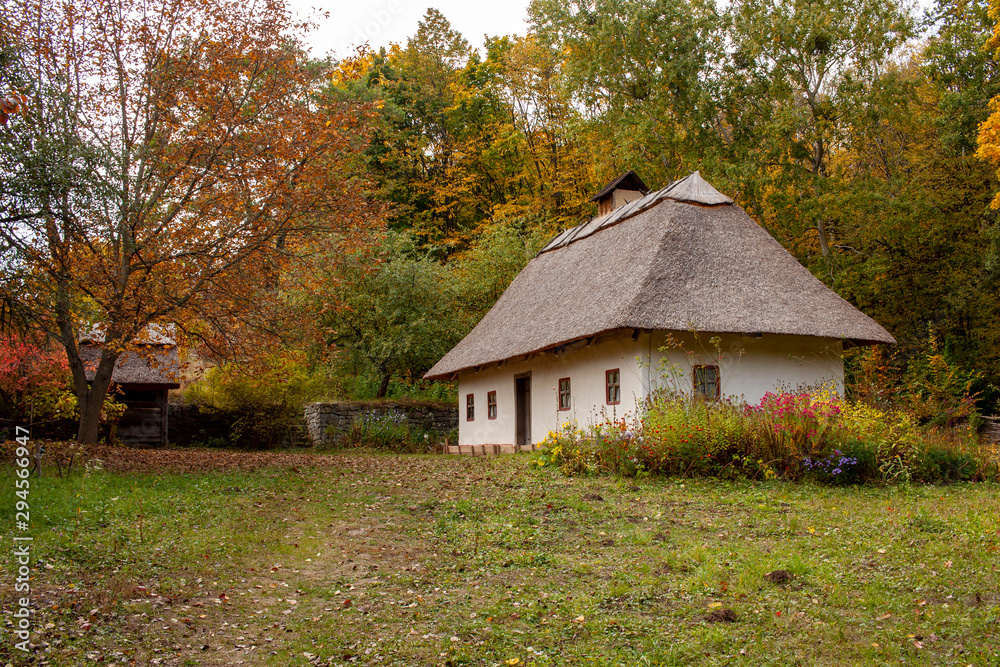 Old rural wooden house with thatched roof. Fall season. Close-up. Old rural wooden house with thatched roof. Fall season. Close-up.