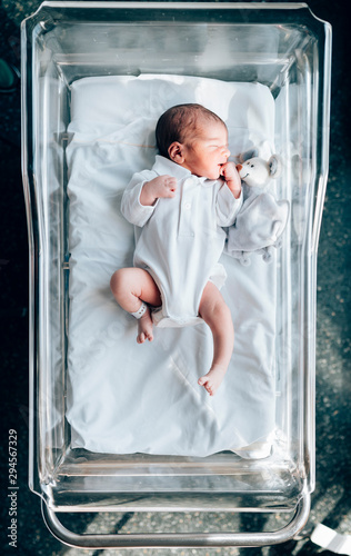 Newborn boy sleeping in his hospital bed