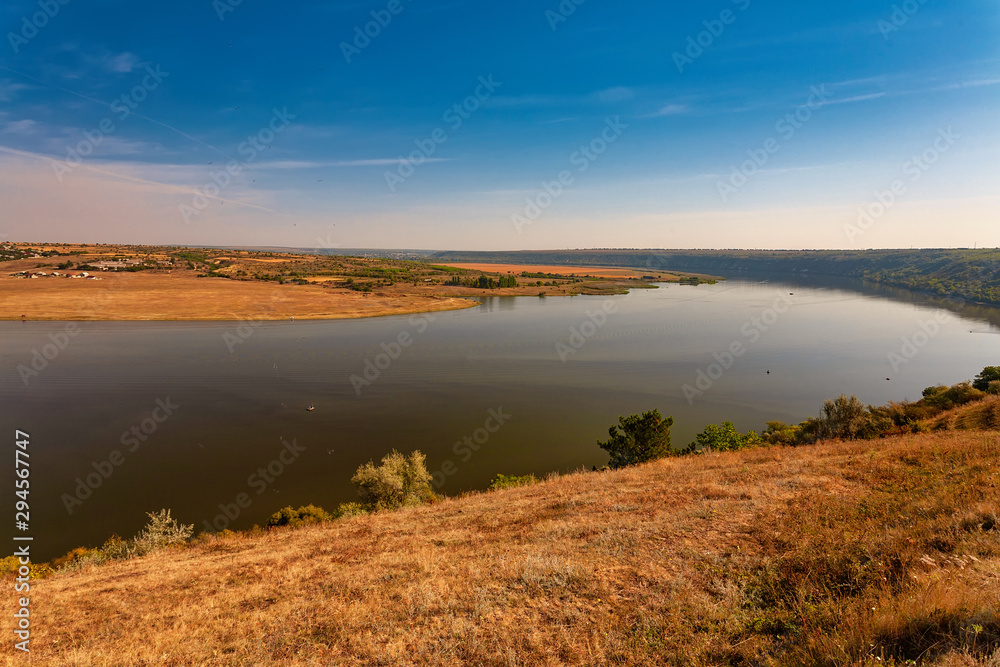 Beautiful autumn landscape with a river in the early morning, The Dniester river in Moldova near the village of Molovata Beautiful autumn landscape with a river in the early morning, The Dniester river in Moldova near the village of Molovata