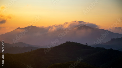 Landscape of the sunrise over the mountain with fog in the morning at Kanchanaburi provice , Thailand.