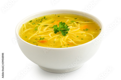 Instant chicken noodle soup in a white ceramic bowl isolated on white. Parsley garnish. photo