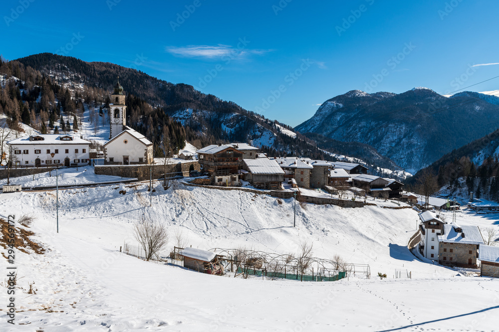 Winter in Sauris di Sotto. Magic of snow and old wooden houses. Italy