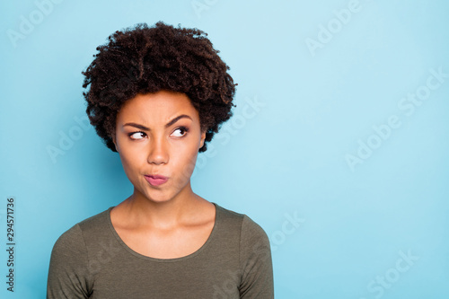 Hmm... interesting. Portrait of serious expression emotions minded afro american girl think try to solve decide solutions be creative wear good look outfit isolated over blue color background