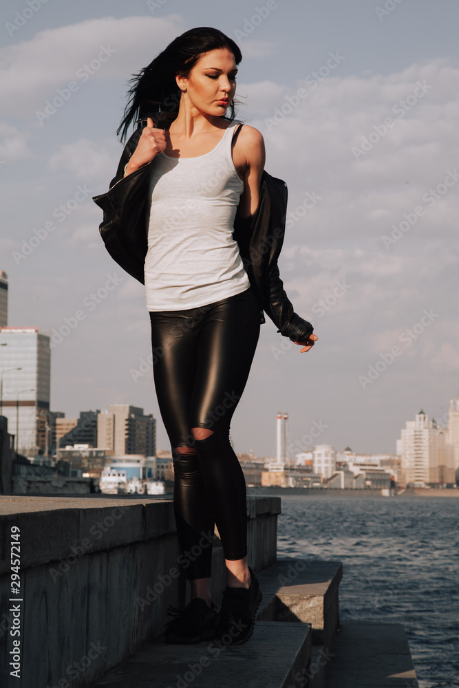 attractive fitness woman lifestyle portrait. caucasian model walking in the city