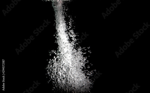 water splash with bubbles of air, isolated on a black background.