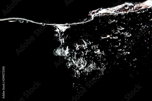 water splash with bubbles of air, isolated on a black background.