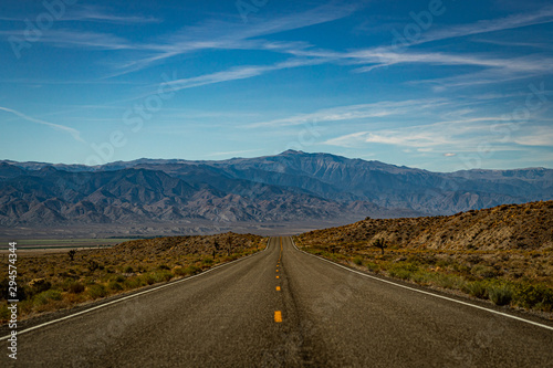 Long and Lonely road in the desert of Nevada leading towards a mountain range with nobody around (2)