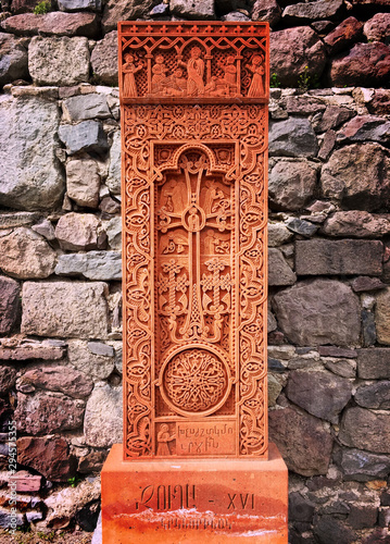 Ancient, orange Geghard khachkar stone photo