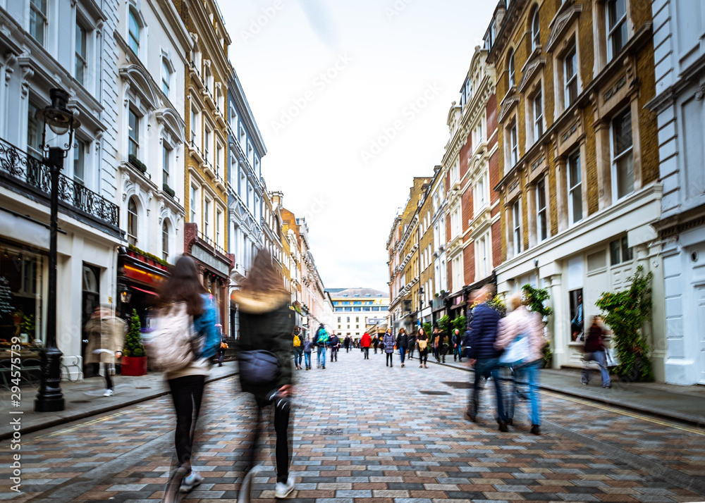 Motion blurred people walking on shopping street