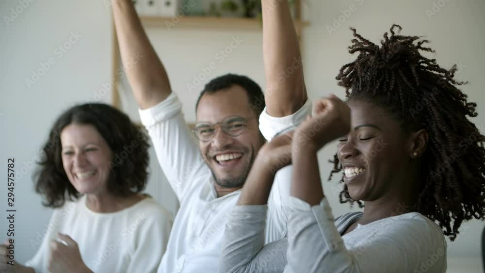 Successful employees talking while sitting at office. Cheerful colleagues working together at modern office. Teamwork concept Successful employees talking while sitting at office. Cheerful colleagues working together at modern office. Teamwork concept