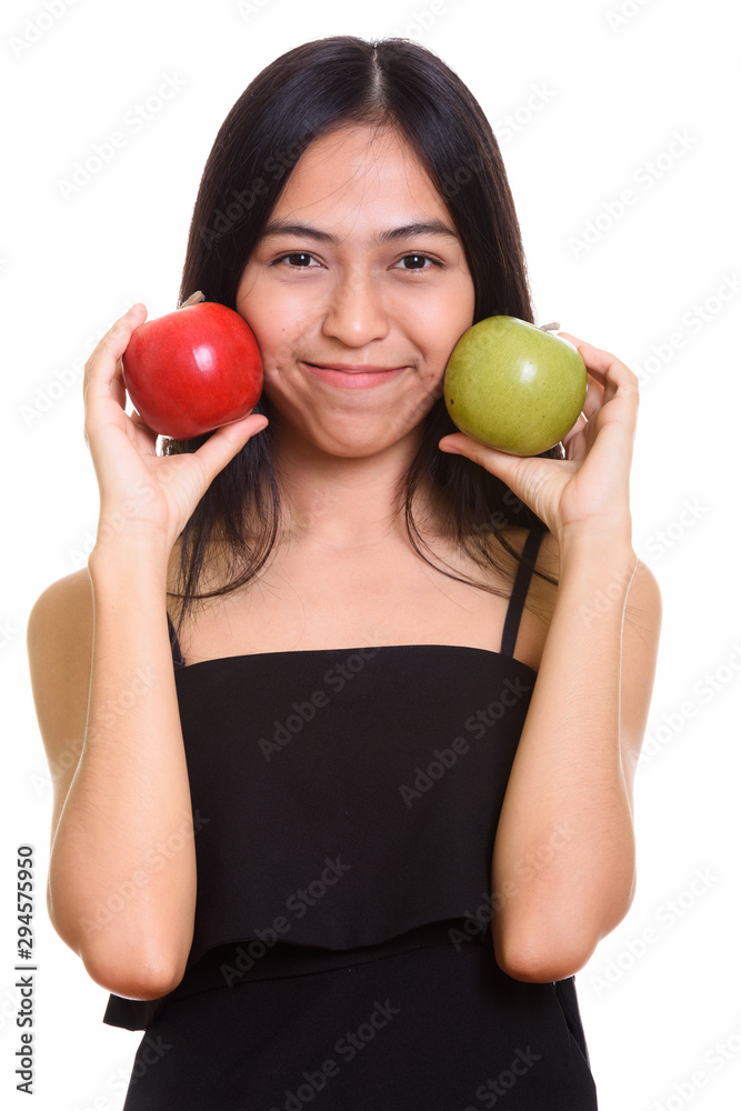 Close up of young Asian teenage girl putting green and red apple Close up of young Asian teenage girl putting green and red apple