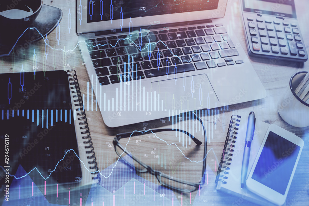 Forex market graph hologram and personal computer on background. Multi exposure. Concept of investment. Forex market graph hologram and personal computer on background. Multi exposure. Concept of investment.