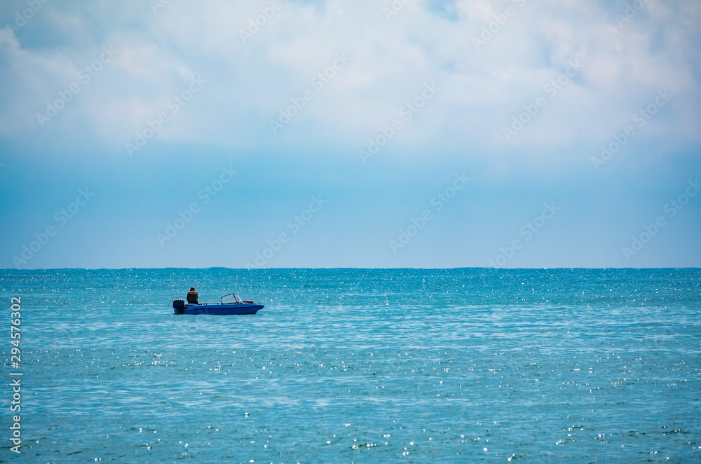 A fisherman is sailing in a boat.