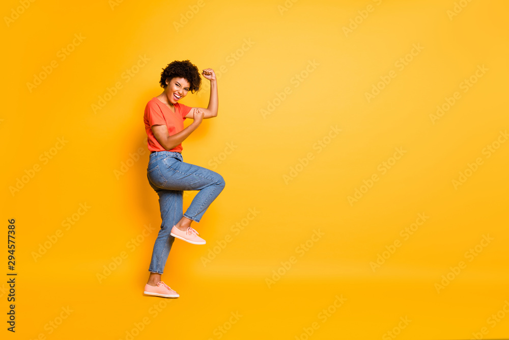 Copyspace photo of charming cheerful cute attractive nice pretty girlfriend wearing jeans denim t-shirt rejoicing with victorious glory isolated over yellow vivid color background
