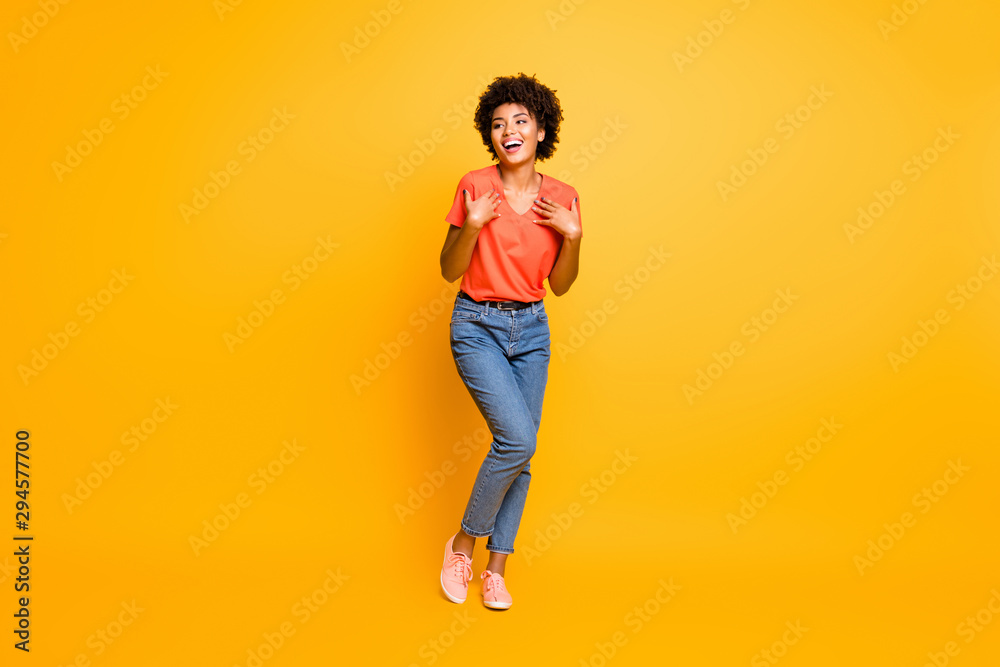 Full length body size photo of cheerful curly wavy black lady wearing jeans denim unable to believe in being chosen excited rejoicing isolated over yellow vivid color background Full length body size photo of cheerful curly wavy black lady wearing jeans denim unable to believe in being chosen excited rejoicing isolated over yellow vivid color background