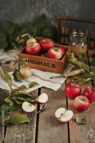 Harvest of red apples on wooden background
