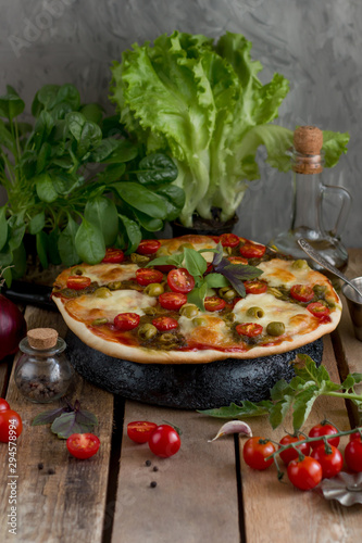 Hot pizza with tomatoes, mozzarella and basil