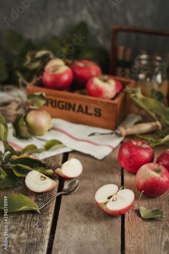 Harvest of red apples on wooden background