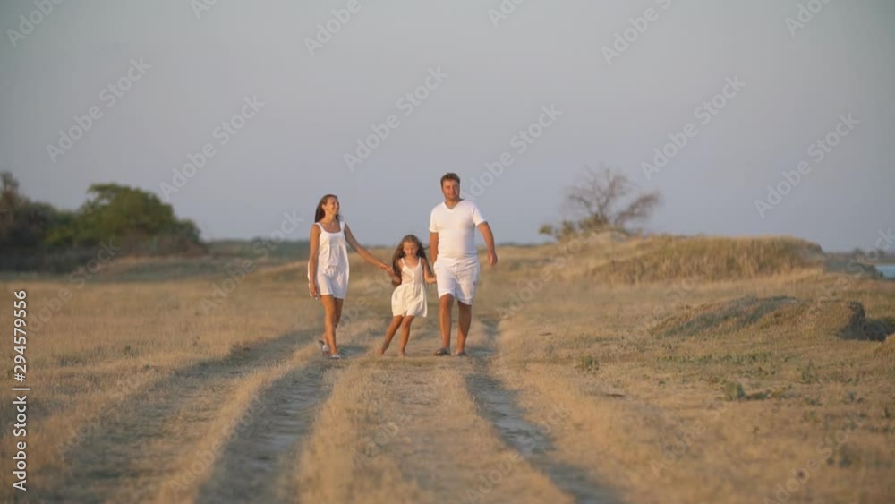 family walks on a dirt road family walks on a dirt road
