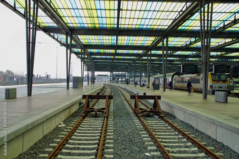 Architecture of a railway station with a train. Structure, and roof of a train station on background. train station interior, belgium, europe