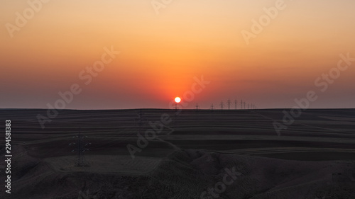 Sunset over plowed farm fields