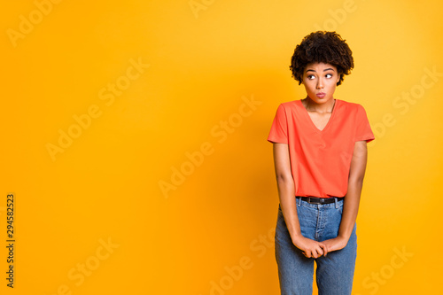 Copyspace photo of cute charming pretty girlfriend unconfident standing hesitating to ask something wearing jeans denim isolated over yellow vivid color background photo