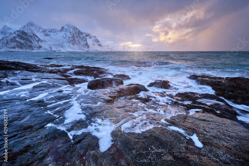 Coast of Norwegian sea on rocky coast in fjord on sunset
