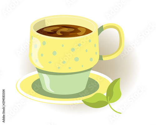 Yellow and green cup of hot beverage with saucer close up