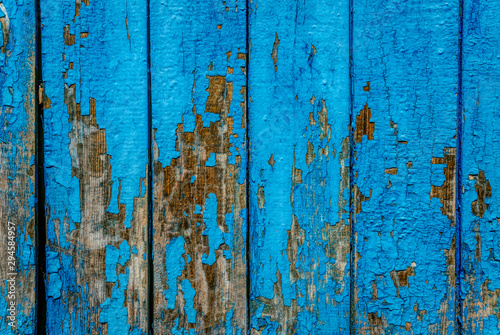 Cracked blue old paint. Old wooden background 