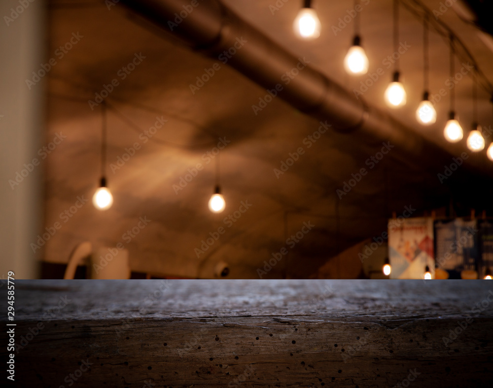 Blurred cafe restaurant club background with wooden table. Place under the text. Empty place. Interer cafe.