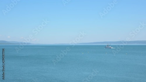 4K Nature Fishing Boat Heading Out To Sea photo
